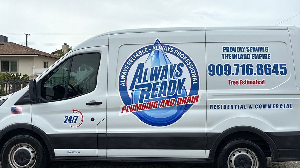 White plumbing service van with logo.