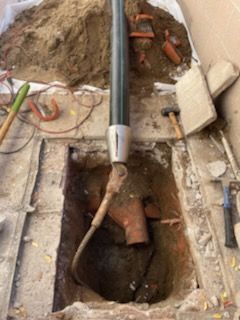 Construction site: Cable being lowered into an underground electrical vault.