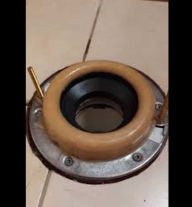 Toilet flange with wax ring and bolts, ready for toilet installation.