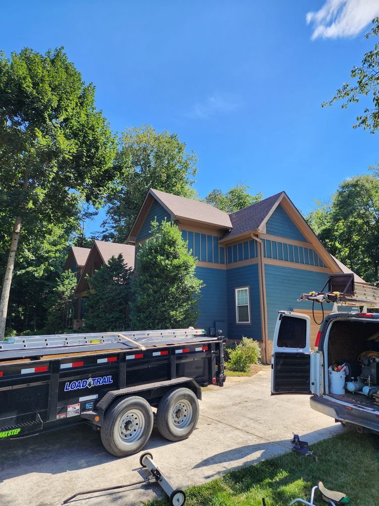 A dump truck is parked in front of a house.