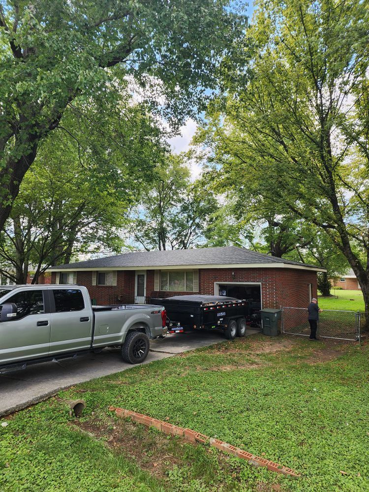 A truck is parked in front of a brick house.