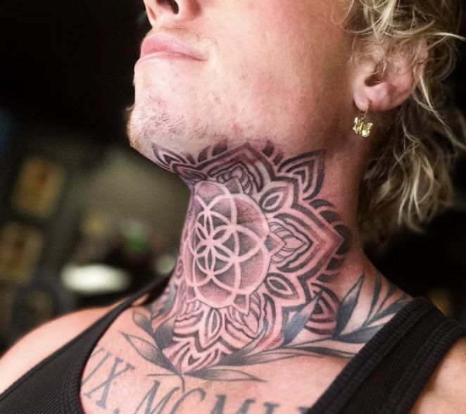 Tattooed neck of a person with a geometric floral design.