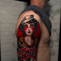 Tattoo of a woman in a sailor hat with red cheeks. Two roses are below.