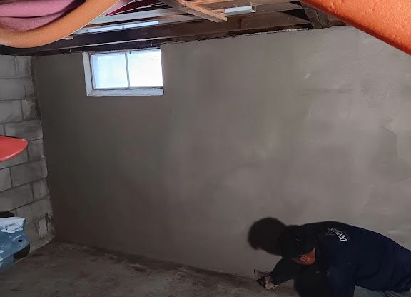 Person bending over in a dim basement-like room with a small window and unfinished walls