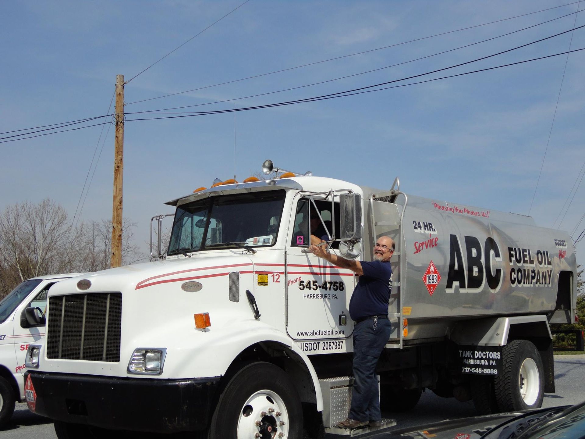 Man by fuel truck for ABC Fuel Oil Company.