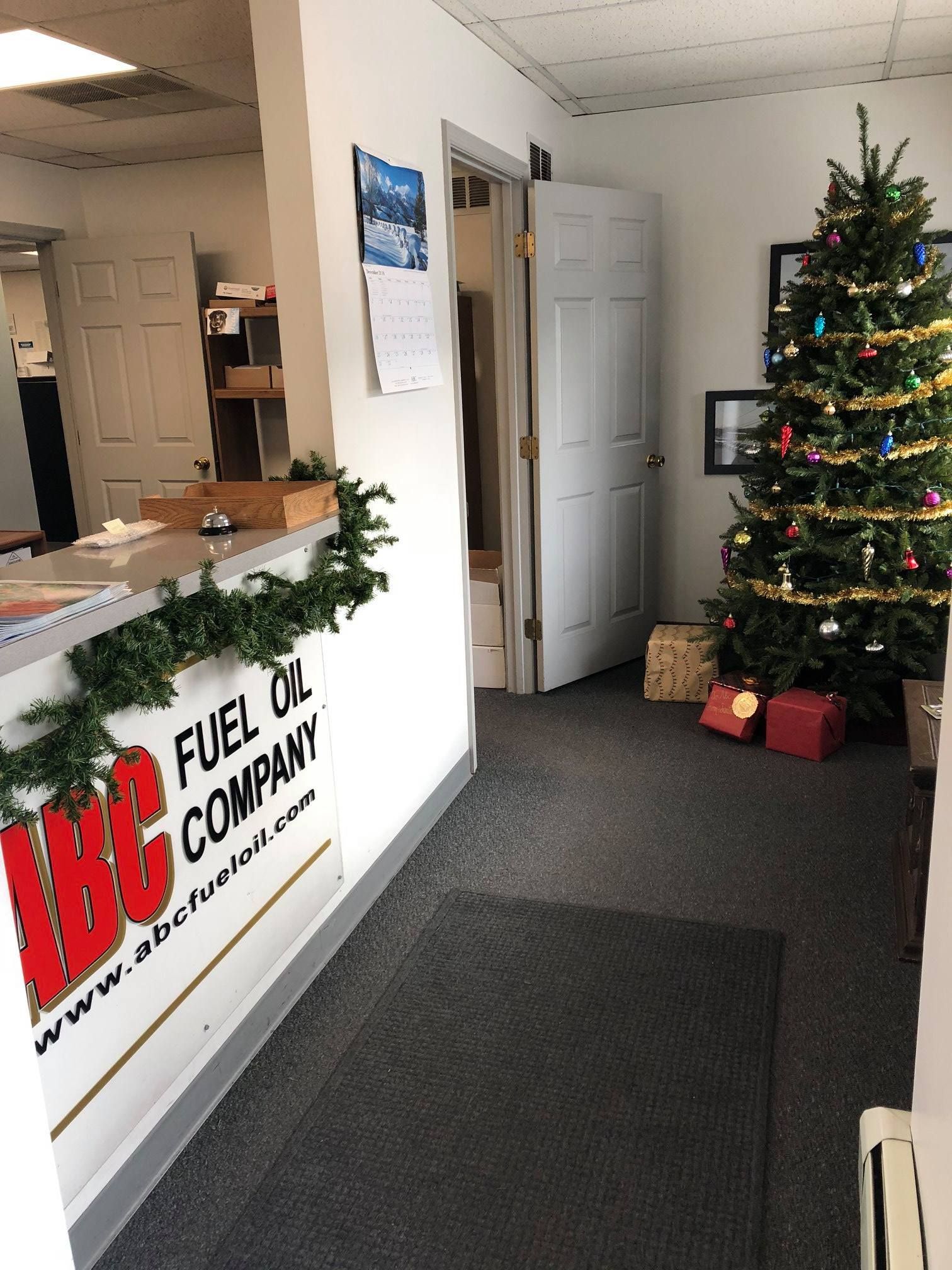 Interior office with a Christmas tree. ABC Fuel Oil Company sign.