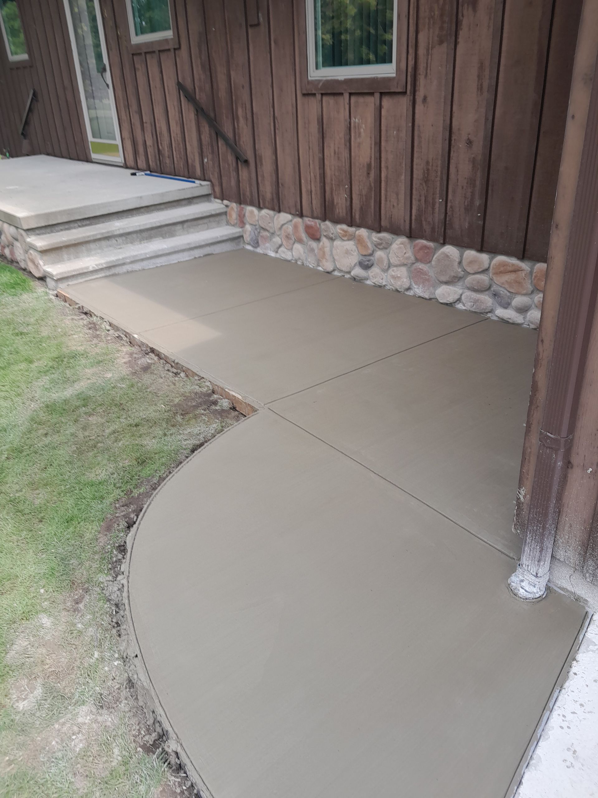 a concrete walkway leading to the front door of a house 