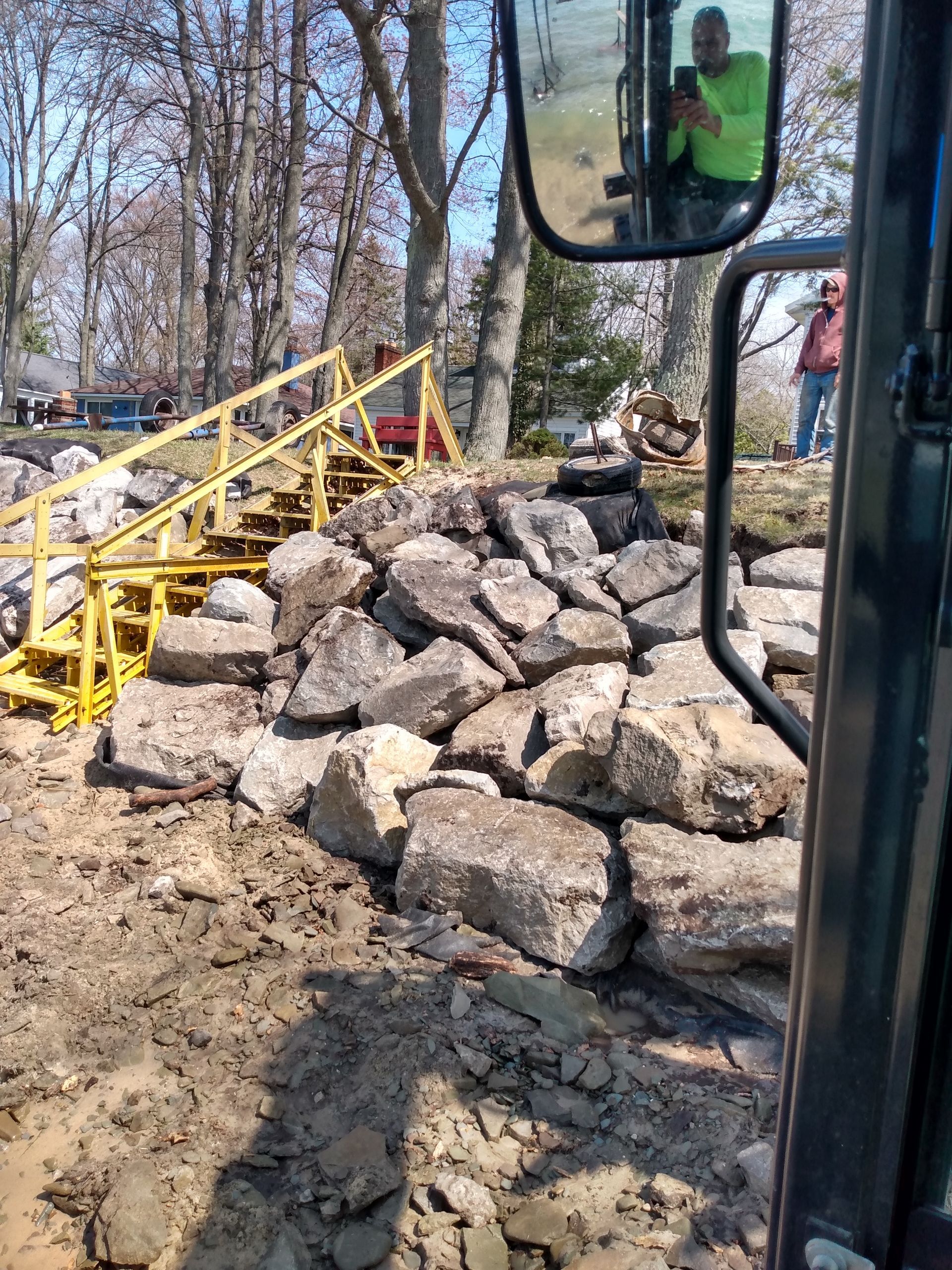 a man is taking a picture of a pile of rocks 