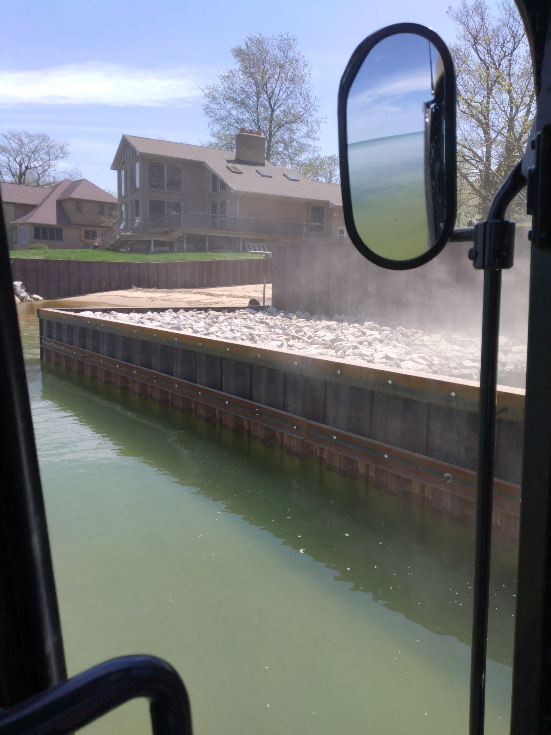 a large body of water with a house in the background