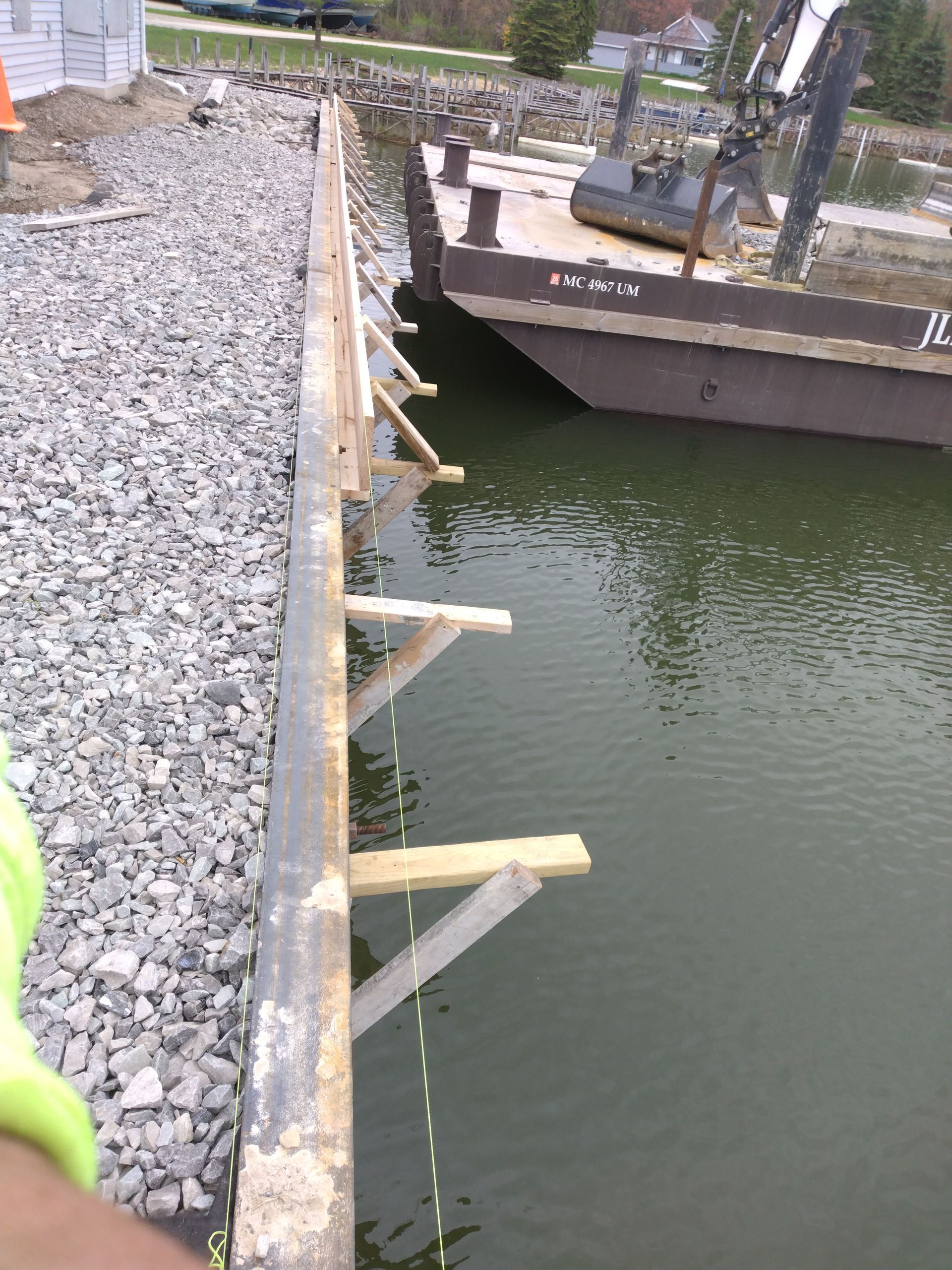 a boat is docked in a body of water next to a rocky shoreline 