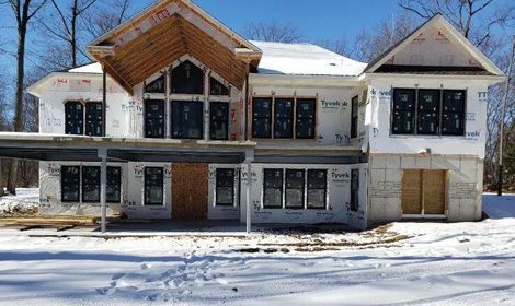 a large house is being built in the snow