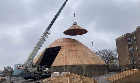 a large dome is being lifted by a crane