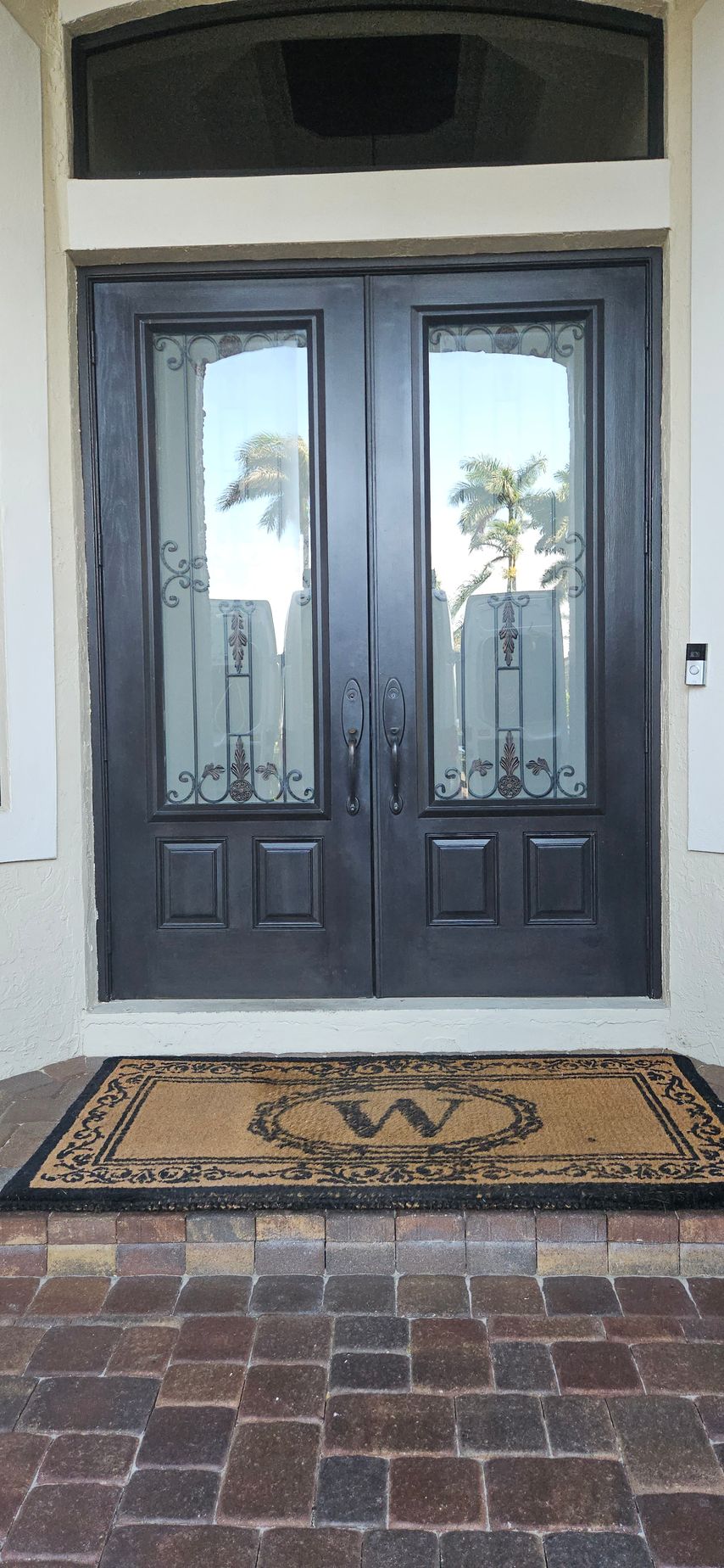 Double black front doors with glass panels,