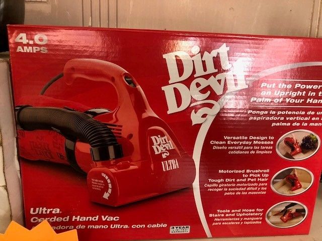A dirt devil vacuum cleaner in a red box