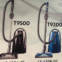 Two vacuum cleaners are sitting next to each other on a table