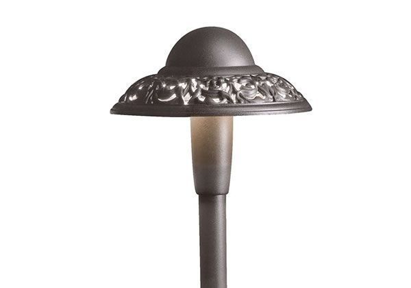 Bronze-colored outdoor path light with a decorative, floral-patterned shade and dome top.