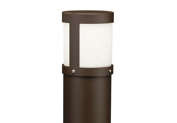 Dark bronze outdoor bollard light with a white, frosted light diffuser.