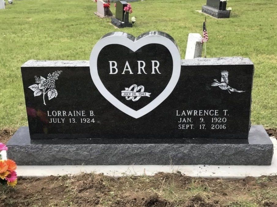 A black gravestone with a white heart and the name barr on it
