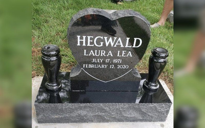 heart-shaped tombstone with 2 candle holders