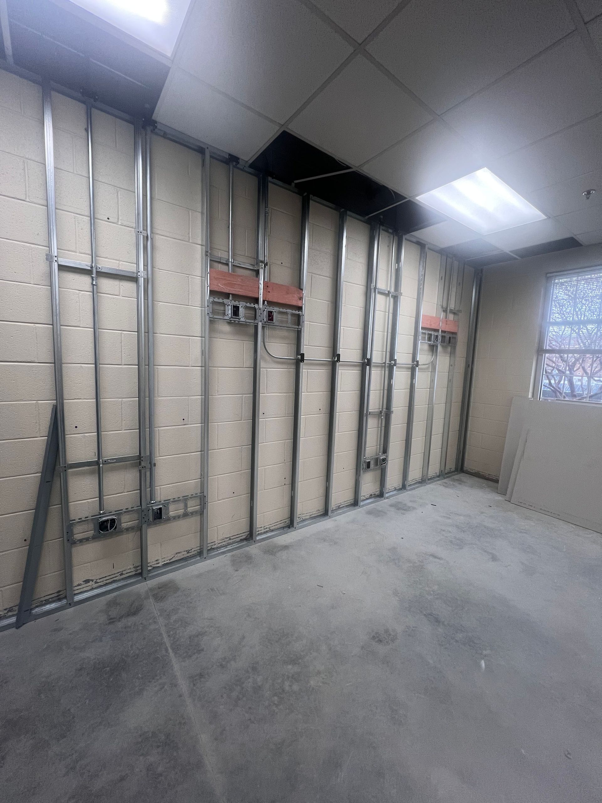 A room with a lot of brick walls and a window.