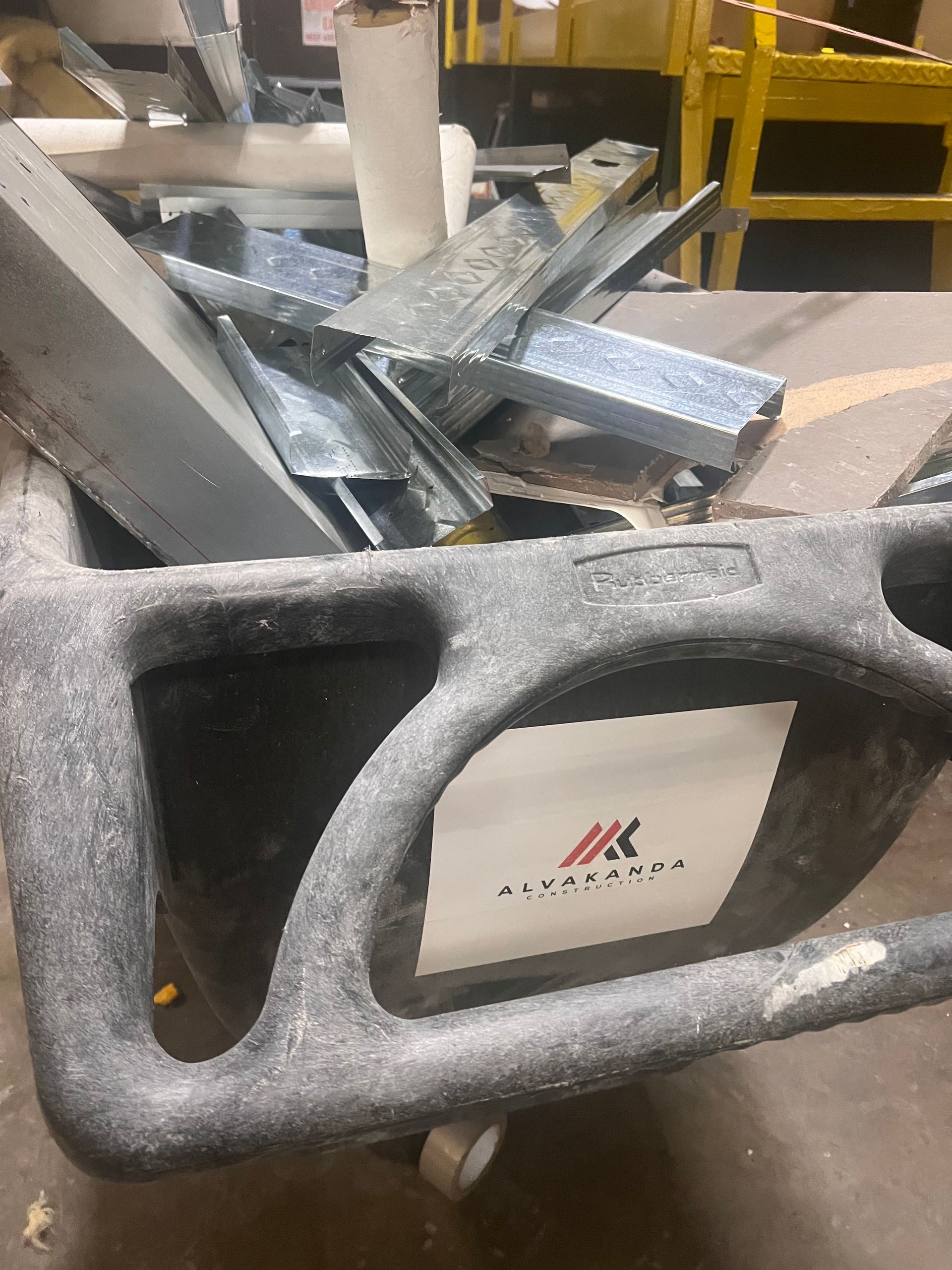 A cart filled with pieces of metal is sitting on a table.