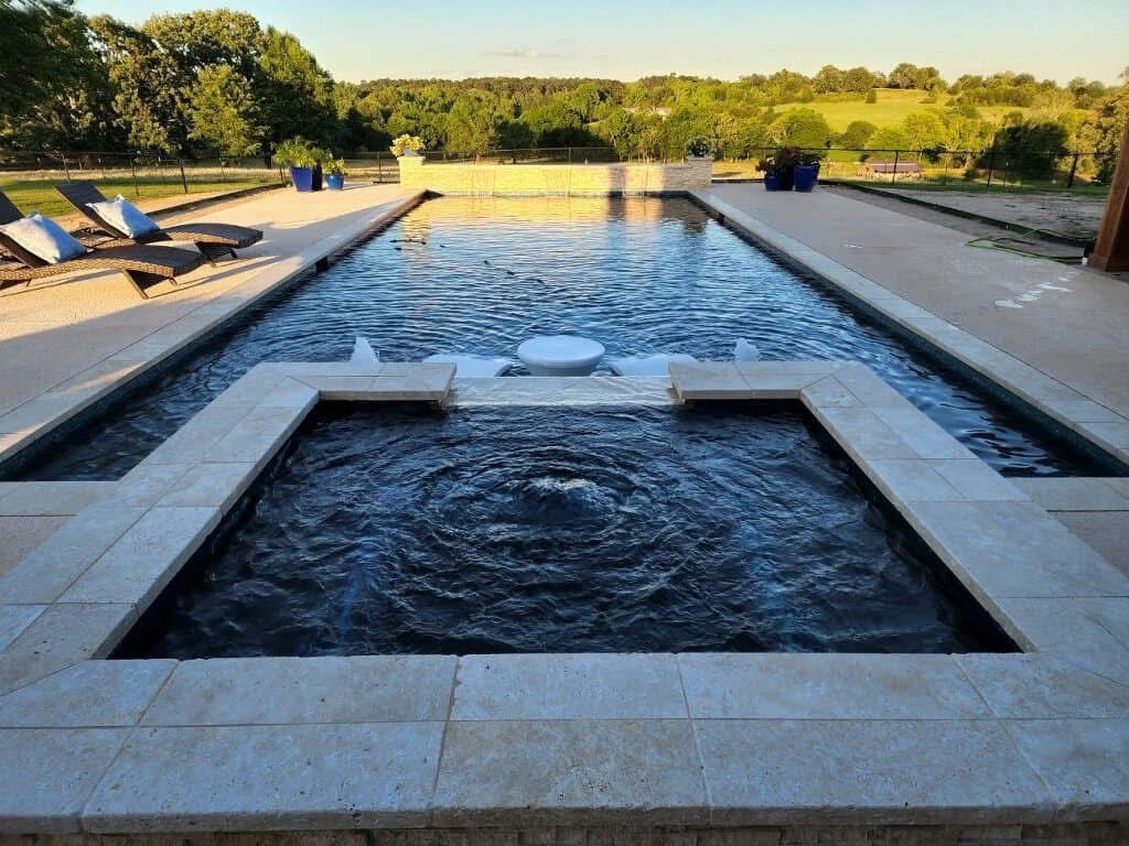 A large swimming pool with a fountain in the middle.