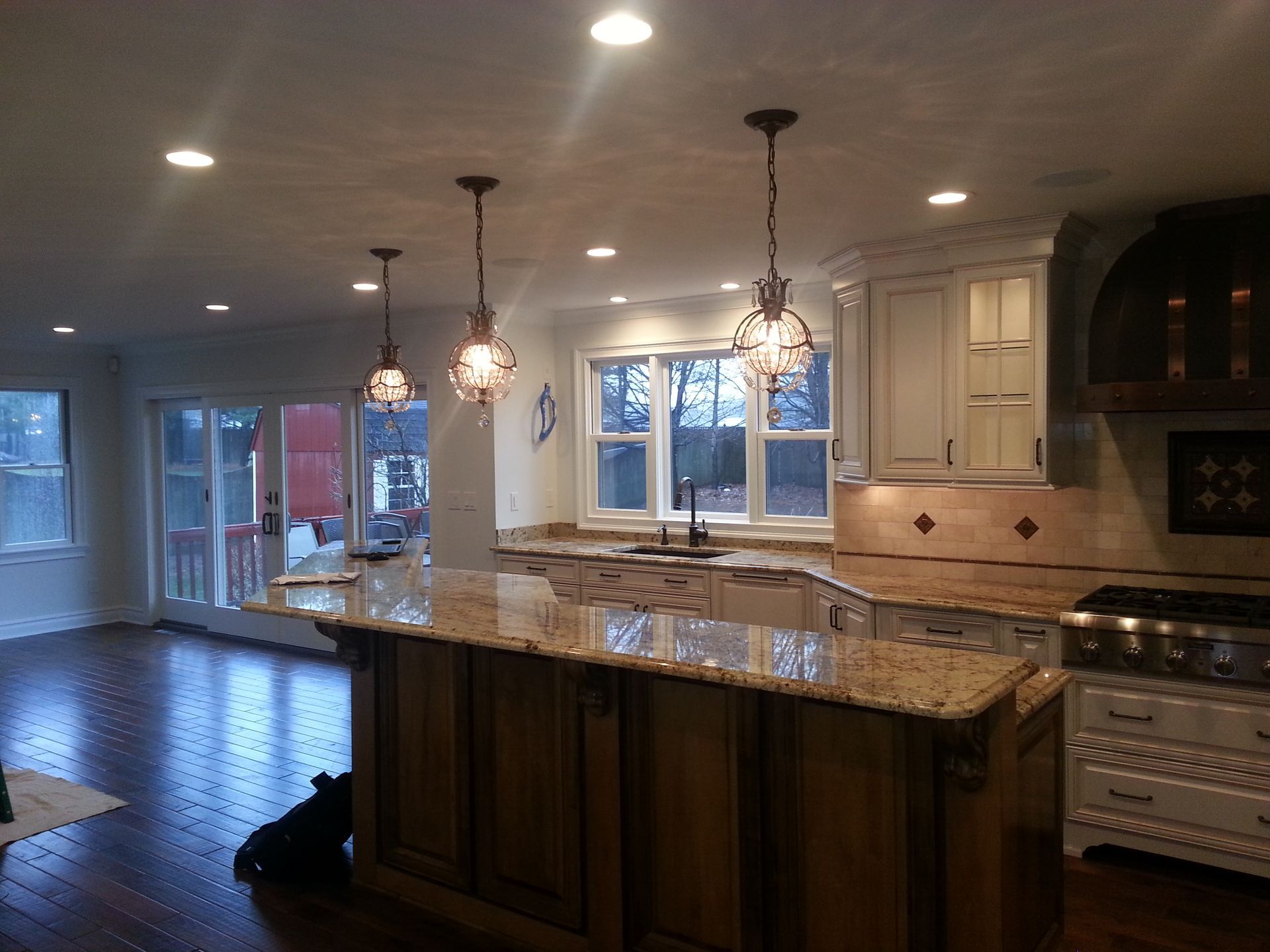 A kitchen with white cabinets and granite counter tops