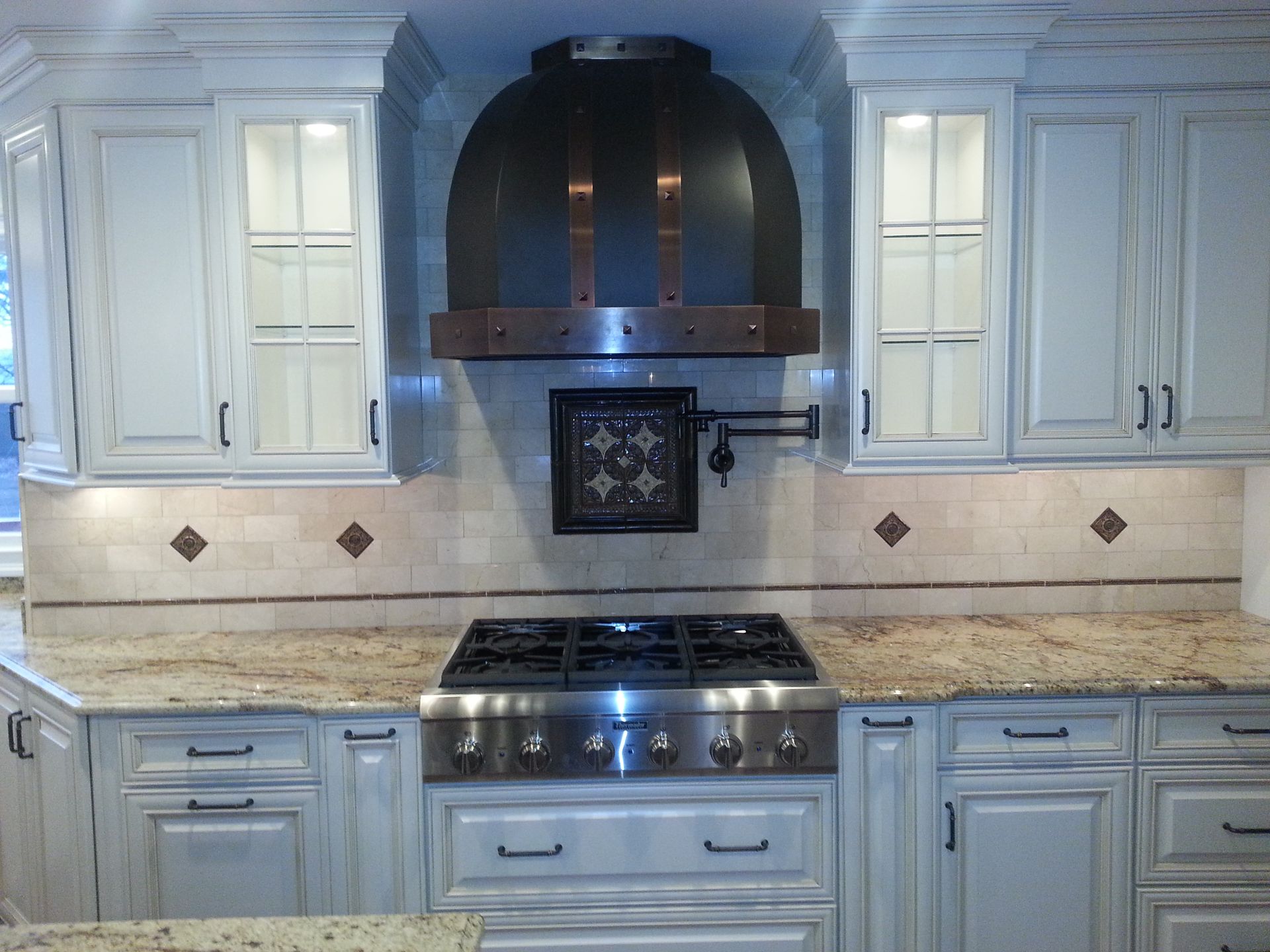 A kitchen with stainless steel appliances and white cabinets