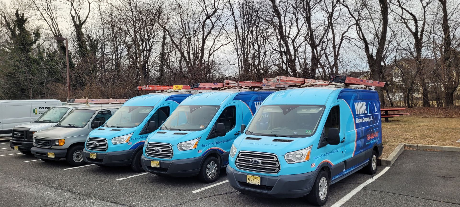 A blue van for wave electric company llc is parked in a parking lot