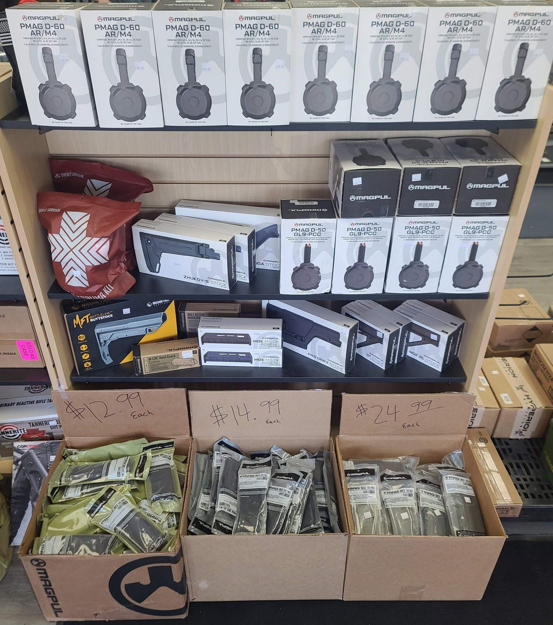 Store shelf and floor boxes of tools and supplies, with boxed items stacked in rows.
