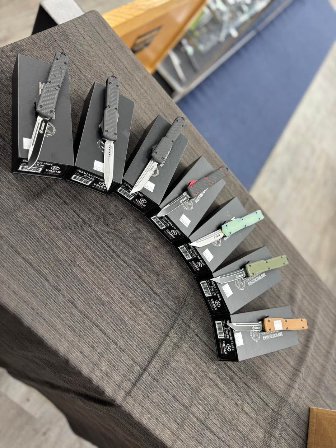 Folded black display cards arranged in a fan on a table, with one light gray card at the end.