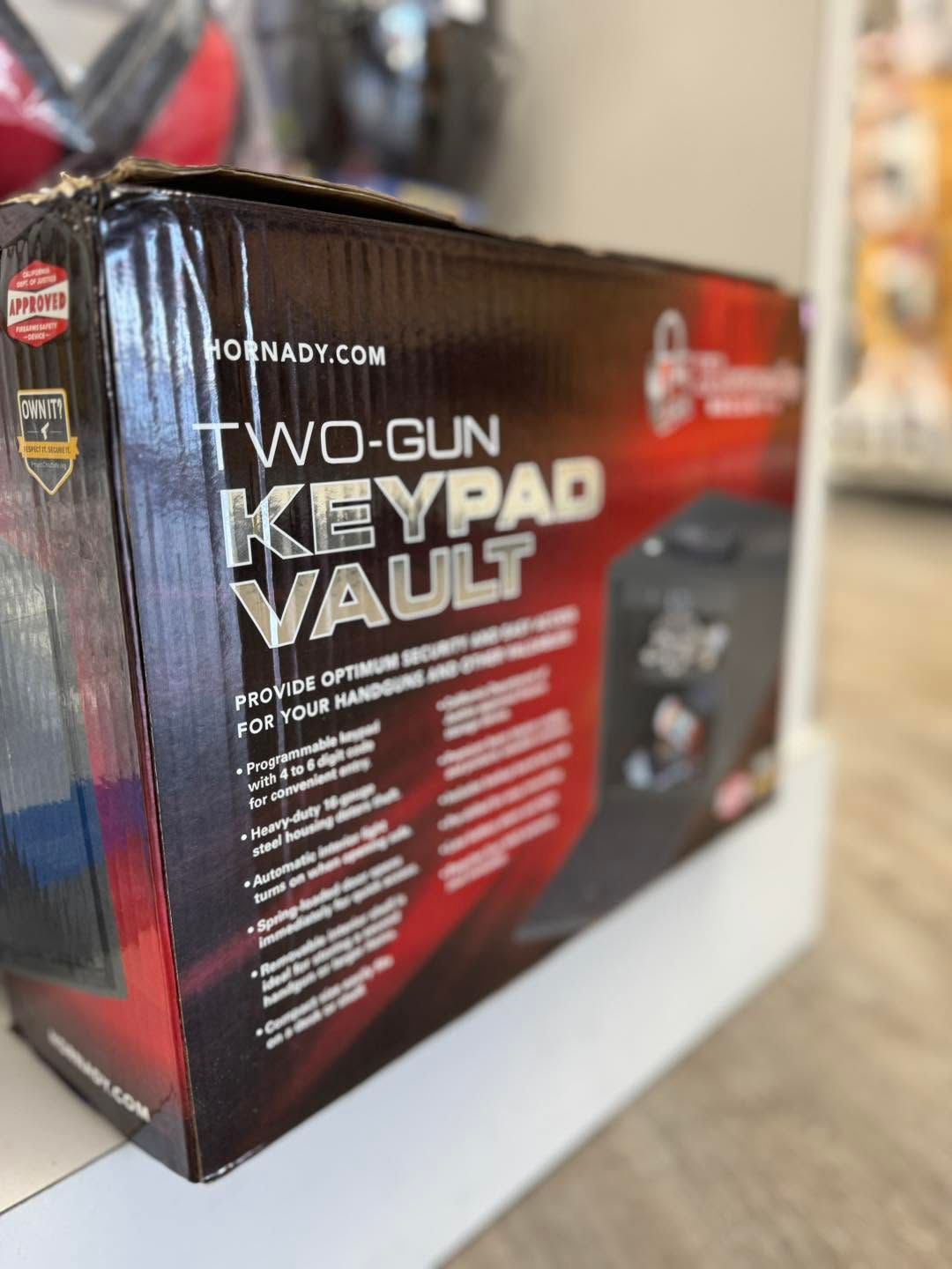 Black and red Hornady two-gun keypad vault box on a white surface