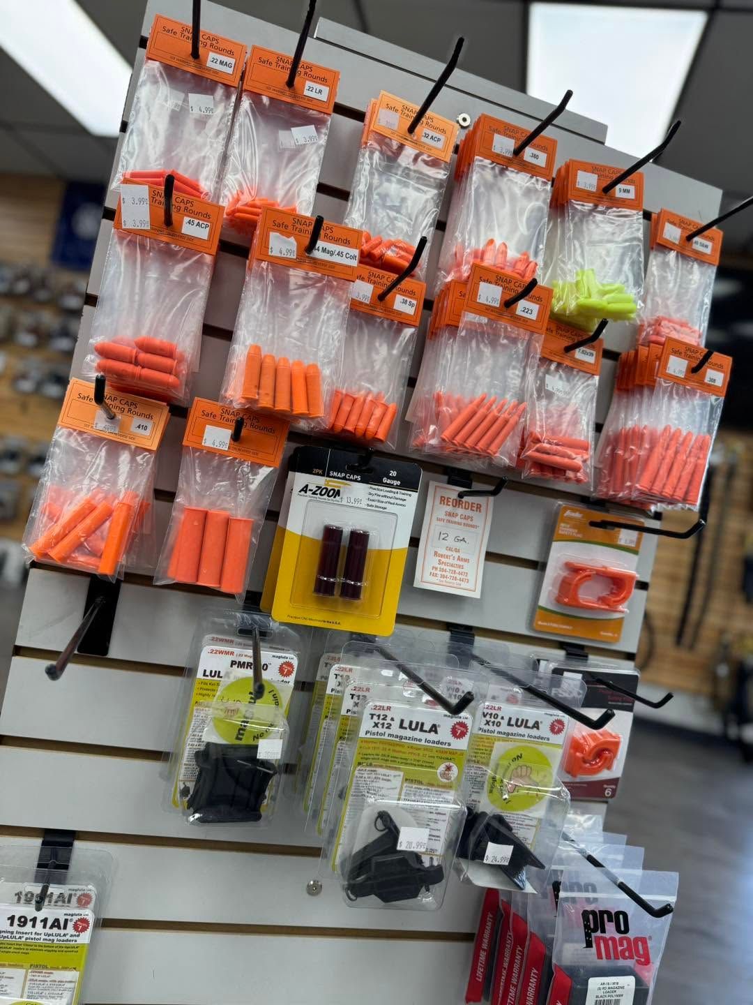 Assorted fishing hooks and tackle packages hanging on a store display rack.
