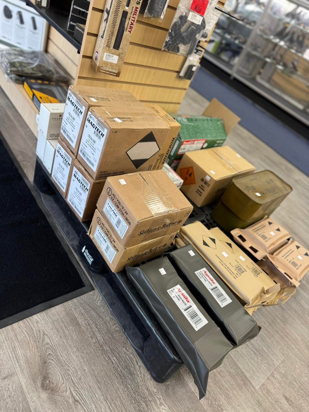 Boxes and parcels stacked on a cart in a store or warehouse aisle