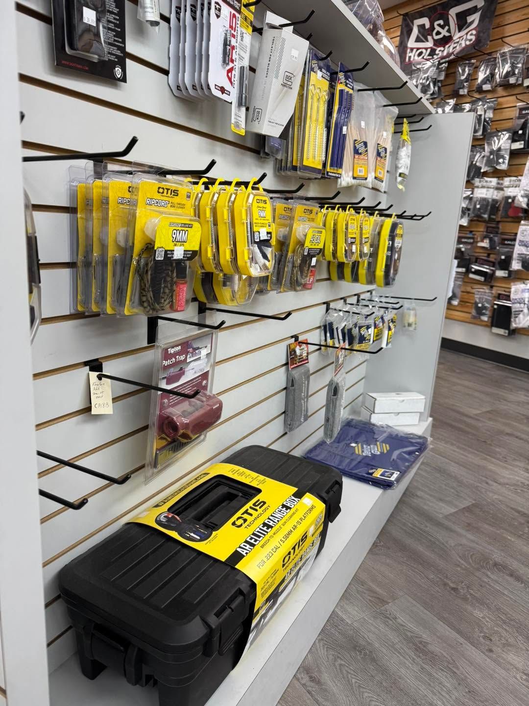Hardware store display of yellow and black tools and accessories on wall racks.