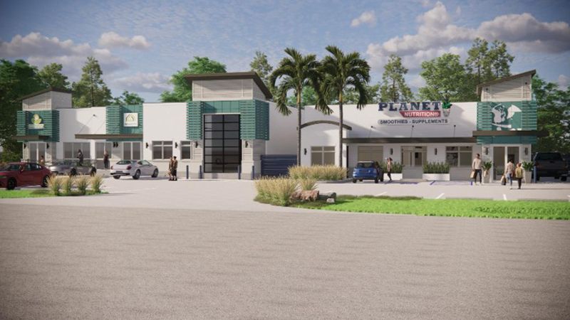 A rendering of a building with a lot of cars parked in front of it.