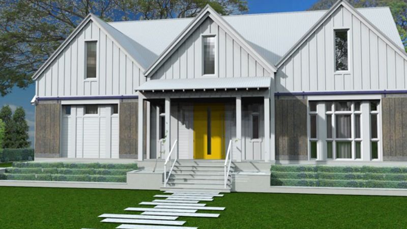 A white house with a yellow door and stairs