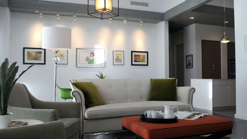 A living room with a couch , chair and coffee table