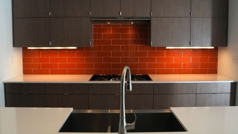 A kitchen with a stove top oven and a sink