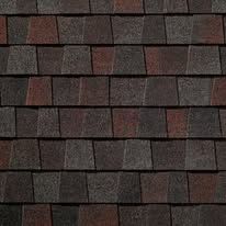 Dark brown and gray overlapping roof shingles in a close-up pattern
