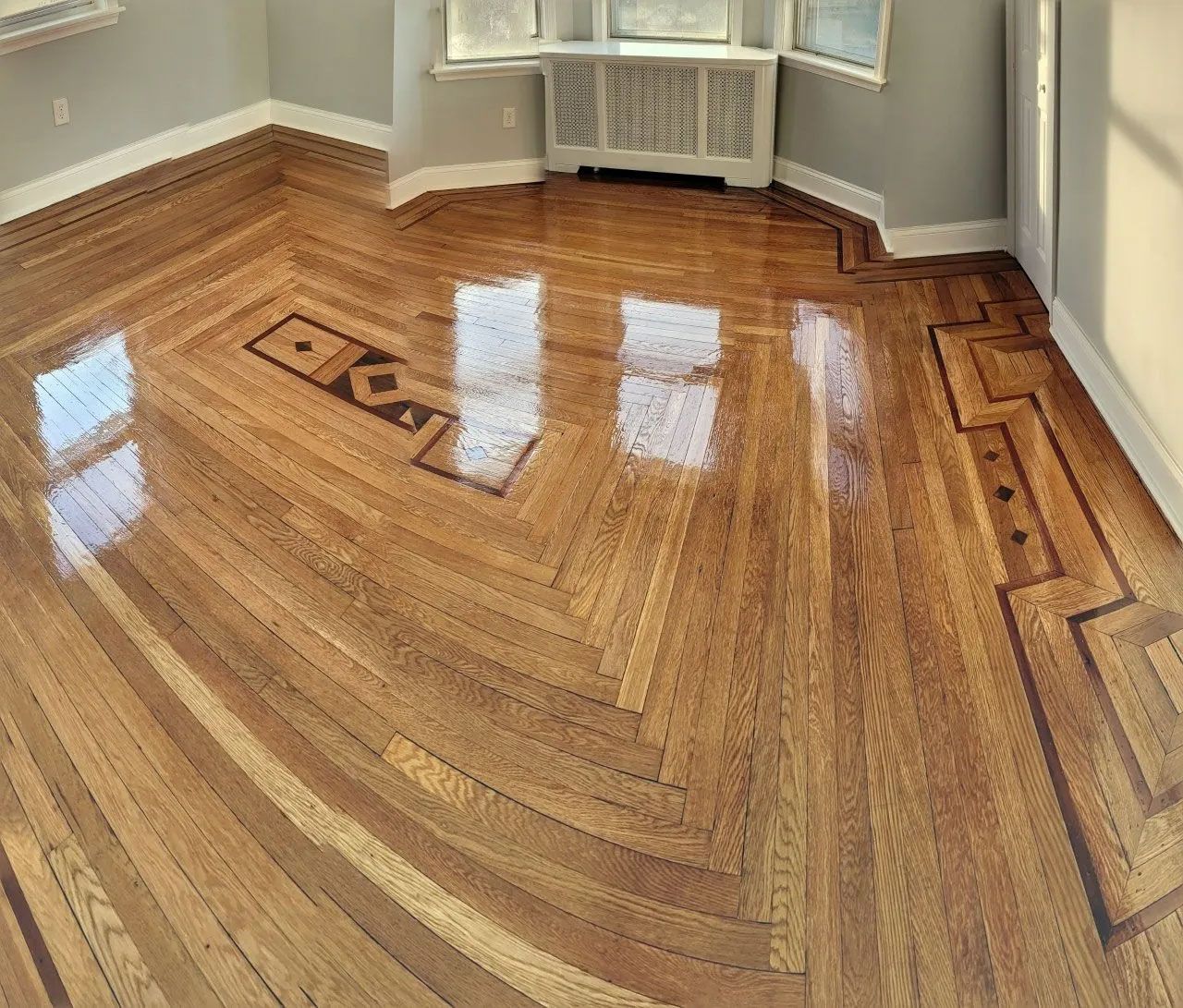 A room with a hardwood floor and a window