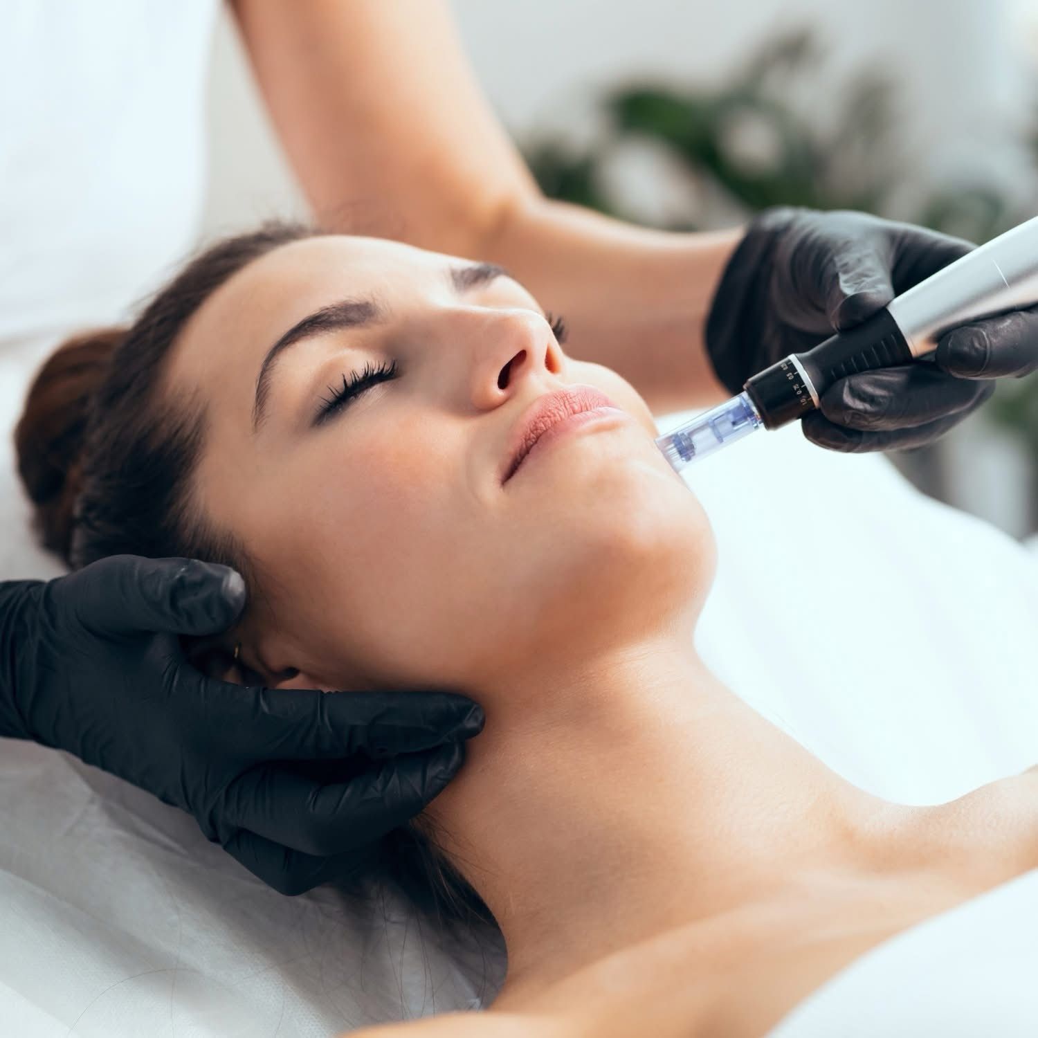 A woman is getting a facial treatment at a beauty salon.