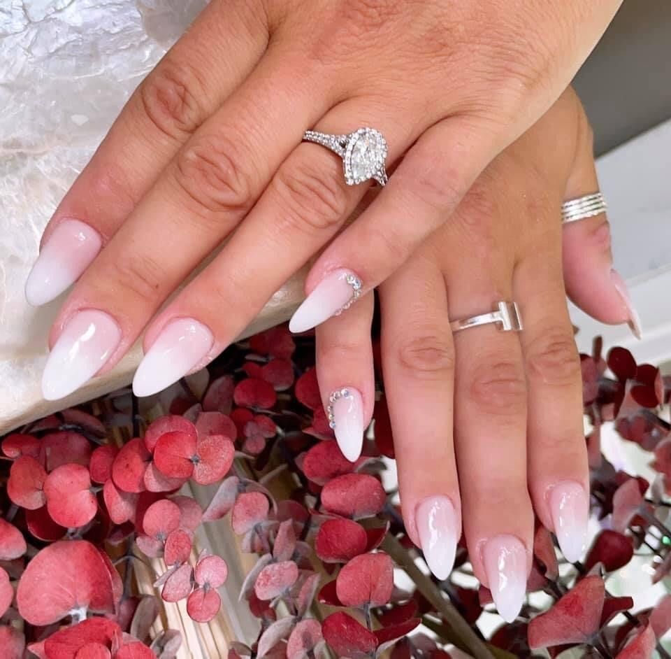 A close up of a woman 's hand with a ring on her finger
