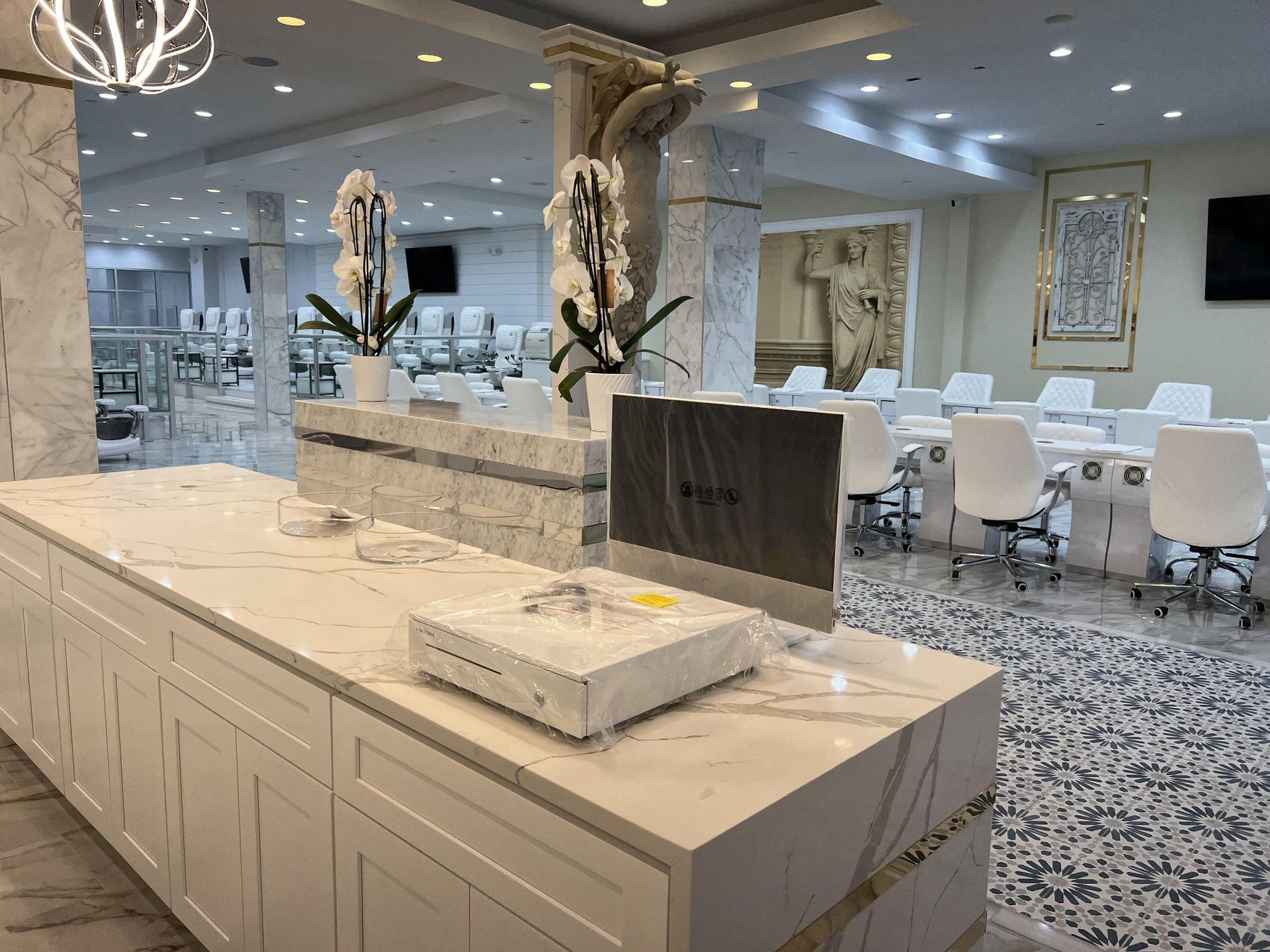 A large room with a lot of white furniture and tables and chairs.