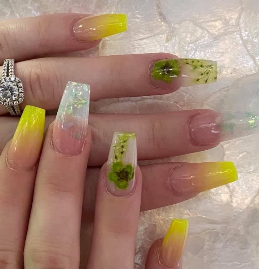 A close up of a woman 's nails with a ring on her finger.