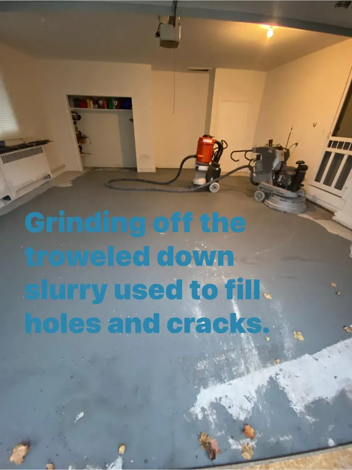 Garage floor grinding, removing slurry used to fill cracks. Two machines working on gray concrete.
