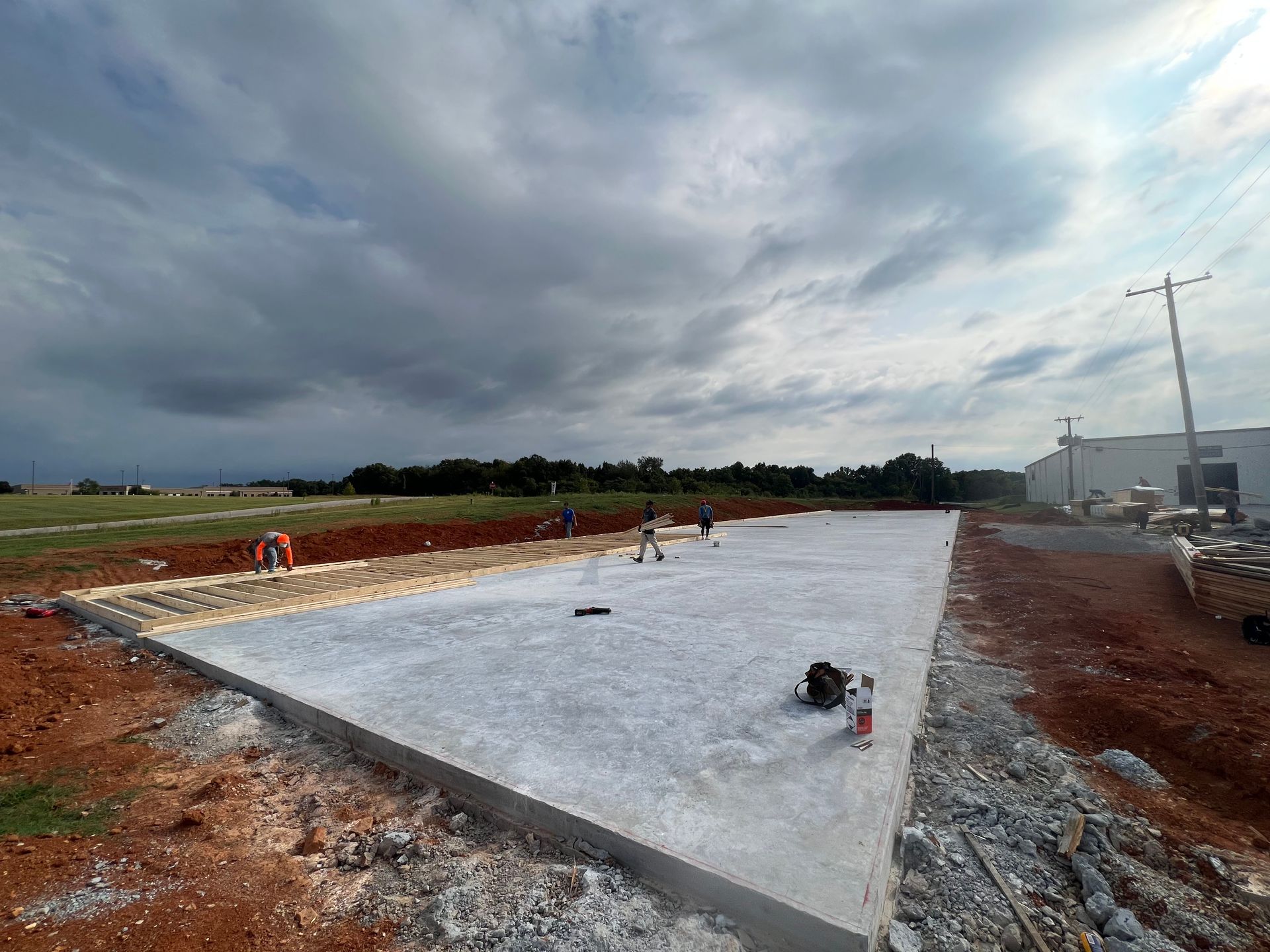 A large concrete slab is being built in a field.