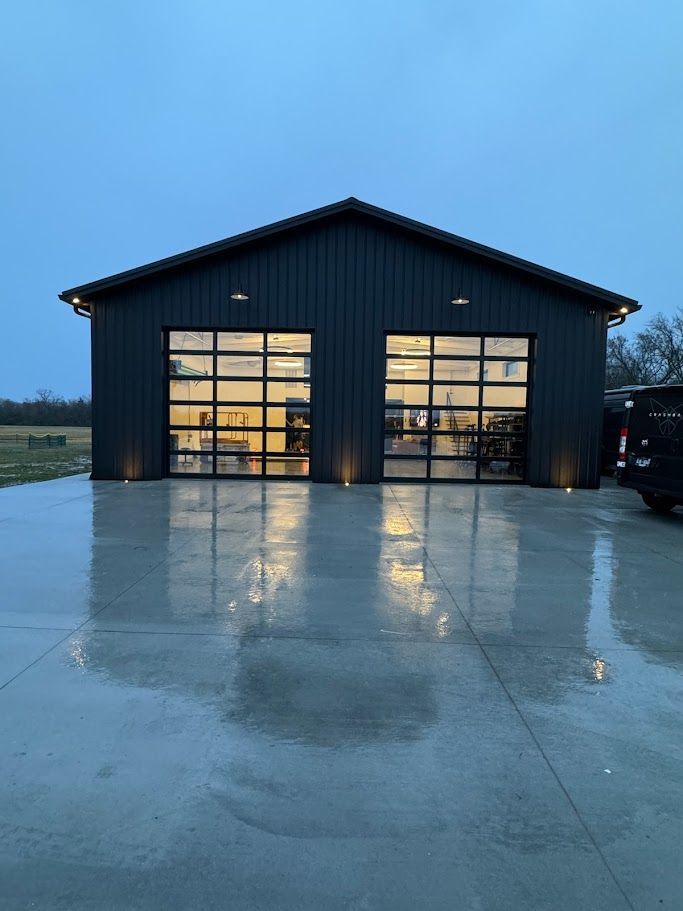 A large black building with a lot of windows and a car parked in front of it.