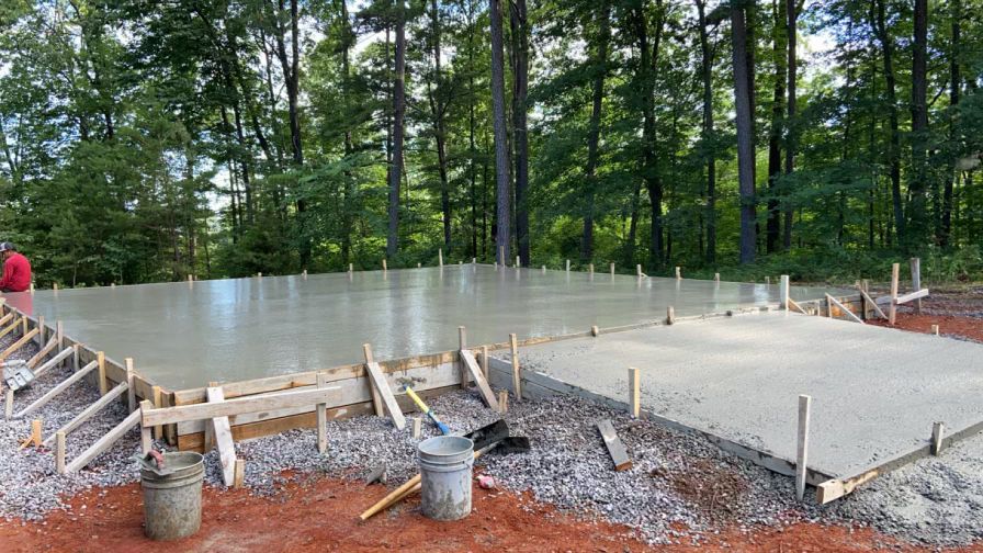 A concrete floor is being built in the middle of a forest.