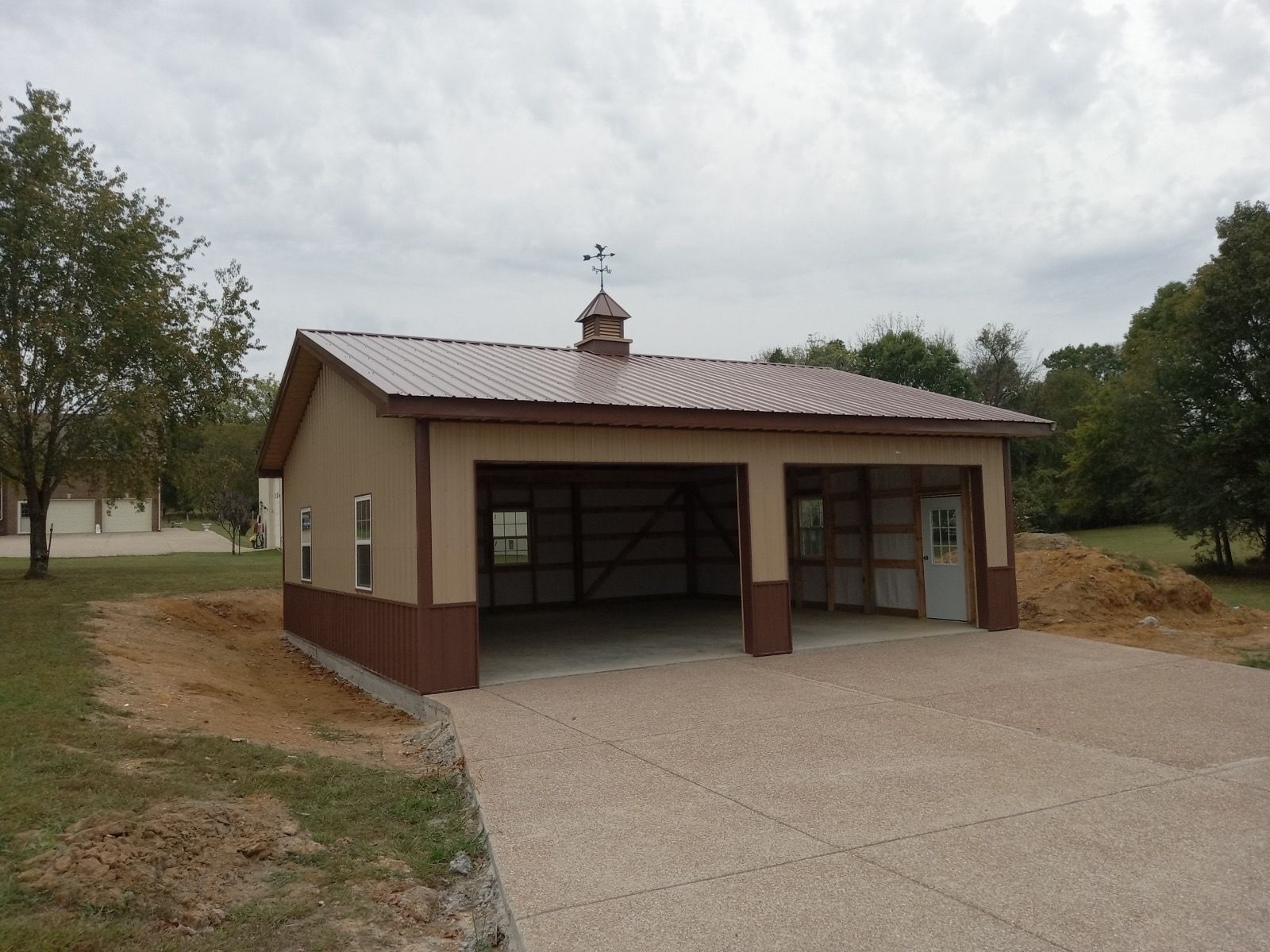 A brown and tan garage with a metal roof